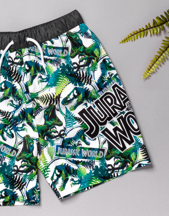 JURASSIC WORLD SWIM SHORTS FOR HIM - The green dinosaur swim shorts come in a black & white colour contrasting with a bold green print of the dinosaur, Tyrannosaurus Rex with foliage and the Jurassic World logo making a must have Jurassic World gift for boys!