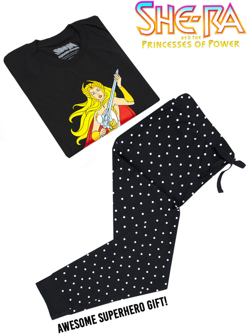 MASTERS OF THE UNIVERSE SHE-RA SHIRT & BOTTOMS PJ SET FOR WOMEN - Our ladies She-Ra tee has short sleeves and a stylish crew neck matched perfectly with black dotty lounging bottoms. It is the perfect superhero gift for all fans of the classic 1987 animated movie, She-ra: Princess of Power!